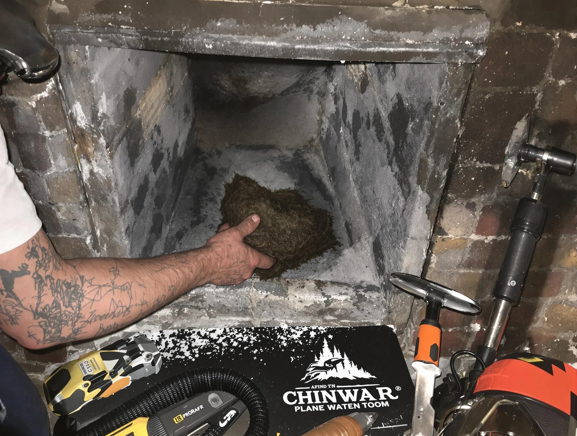 Woburn Chimney Sweep safely removing debris and screening chimney in Woburn, MA